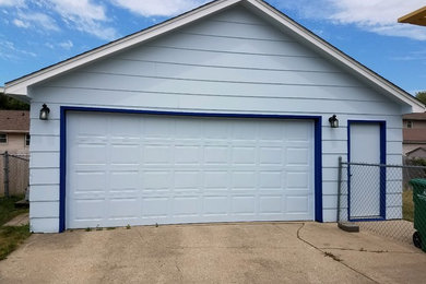 Mid-sized elegant detached one-car garage photo in Other