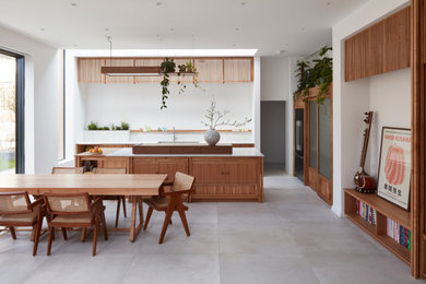 Example of a large danish porcelain tile, gray floor and wood wall great room design in Other with white walls and no fireplace