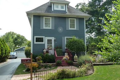 Mid-sized traditional blue three-story wood exterior home idea in Chicago with a hip roof