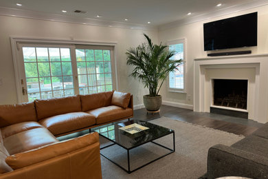 This is an example of a modern games room in Philadelphia with a standard fireplace.