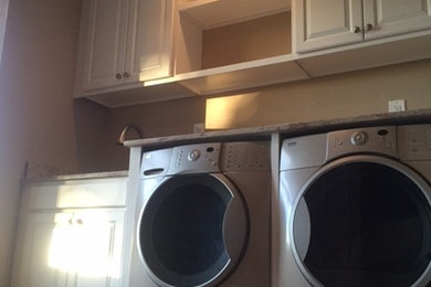 Utility room - mid-sized transitional u-shaped ceramic tile utility room idea in Phoenix with an undermount sink, raised-panel cabinets, white cabinets, granite countertops, beige walls and a side-by-side washer/dryer