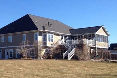 Large arts and crafts brown two-story concrete fiberboard house exterior photo in Indianapolis with a shingle roof