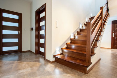 Mid-sized trendy wooden straight wood railing staircase photo in Miami with wooden risers