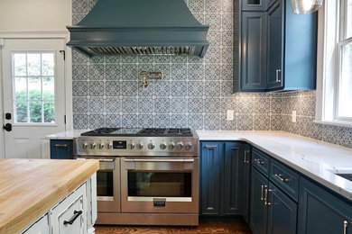 Inspiration for a transitional medium tone wood floor kitchen remodel in Other with blue cabinets, quartz countertops, ceramic backsplash and stainless steel appliances