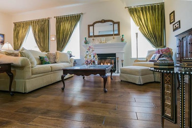 Large elegant formal and open concept medium tone wood floor and brown floor living room photo in Other with beige walls, a standard fireplace and a plaster fireplace