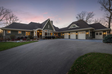 Inspiration for a large timeless one-story wood house exterior remodel in Minneapolis with a hip roof and a shingle roof