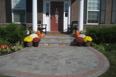 Inspiration for a mid-sized traditional front yard brick garden path in DC Metro.