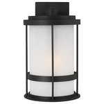 Sea Gull Lighting - Sea Gull Wilburn Medium 1 Light Outdoor Wall Lantern, Black/Satin - With a nod to retro-industrial chic, the Wilburn outdoor fixtures wraps a white frosted glass shade in a fun metal cage to create a casual and easygoing look. Offered in Antique Bronze and Black finishes with Etched White glass, the assortment includes a one-light outdoor pendant, small medium, large, and extra-large one-light outdoor wall lanterns, a one-light out door post lantern and a one-light outdoor ceiling flush mount. Both incandescent lamping and ENERGY STAR-qualified LED lamping are available for most of the fixtures, and some can easily convert to LED by purchasing LED replacement lamps sold separately.