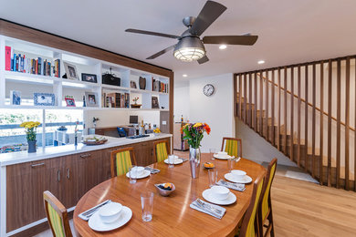 Inspiration for a mid-sized contemporary light wood floor and brown floor great room remodel in Los Angeles with white walls and no fireplace