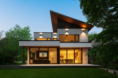 Inspiration for a large contemporary two-storey white house exterior in Toronto with a shed roof.