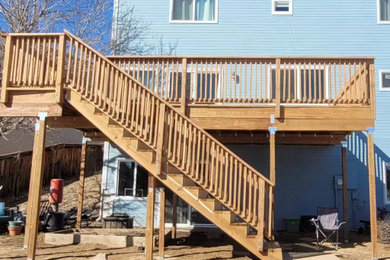Deck - backyard second story wood railing deck idea in Denver with no cover
