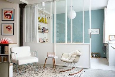 Inspiration for a mid-sized scandinavian enclosed living room in Paris with white walls, concrete floors, no fireplace and no tv.