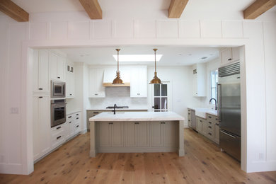 Kitchen pantry - large country u-shaped light wood floor and brown floor kitchen pantry idea in San Francisco with a farmhouse sink, shaker cabinets, gray cabinets, quartzite countertops, multicolored backsplash, marble backsplash, stainless steel appliances, an island and white countertops