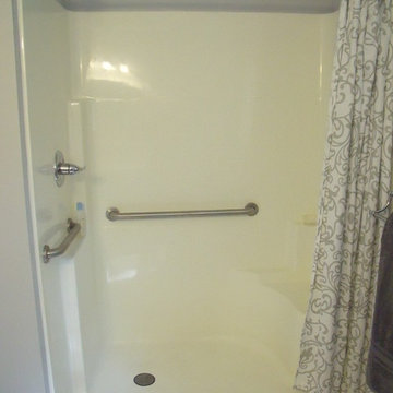 Shower has grab bars, & a shower bench