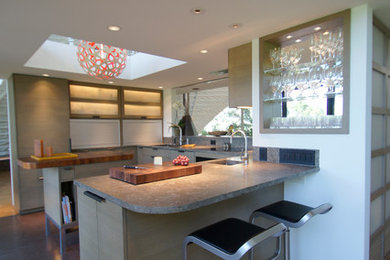 Photo of a mid-sized modern u-shaped separate kitchen in Austin with a single-bowl sink, flat-panel cabinets, grey cabinets, limestone benchtops, multi-coloured splashback, mosaic tile splashback, panelled appliances, cork floors and with island.