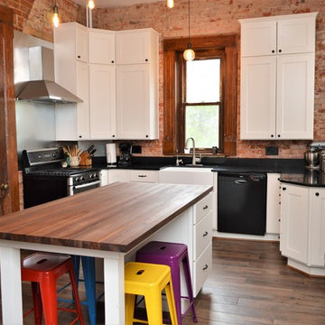 Bourbon, IN. Haas Signature Collection. Farmhouse Kitchen with Exposed Brick