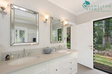 Inspiration for a large country master bathroom in Brisbane with shaker cabinets, white cabinets, a freestanding tub, a corner shower, a one-piece toilet, white tile, porcelain tile, grey walls, porcelain floors, an undermount sink, engineered quartz benchtops, grey floor and a hinged shower door.