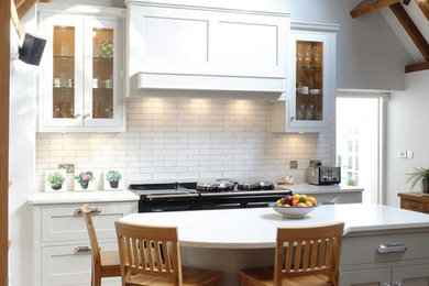 Photo of a small country kitchen in Other with a belfast sink, shaker cabinets, grey cabinets, quartz worktops, white splashback, ceramic splashback, stainless steel appliances, limestone flooring, an island, beige floors and white worktops.