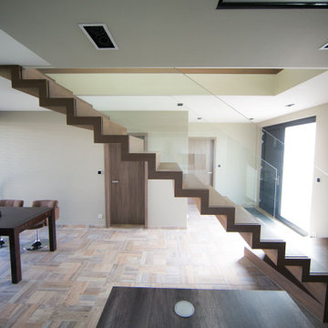 Zig zag staircase in wood with glass balustrade