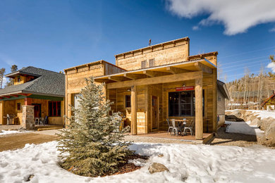Inspiration for a small rustic brown one-story wood house exterior remodel in Denver with a shed roof and a metal roof