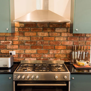 Small farmhouse kitchen pantry designs - Inspiration for a small farmhouse galley linoleum floor and brown floor kitchen pantry remodel in Geelong with a double-bowl sink, laminate countertops, red backsplash, brick backsplash, stainless steel appliances and an island