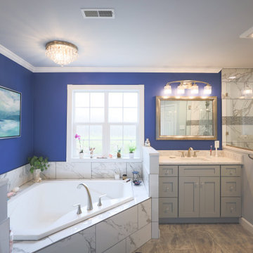Master bathroom remodel in Poquoson with corner bathtub & marble lined tiles