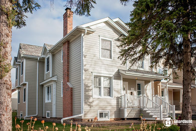 Example of a large arts and crafts beige two-story concrete fiberboard exterior home design in Chicago with a shingle roof