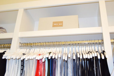 Large trendy women's carpeted walk-in closet photo in Tampa with white cabinets