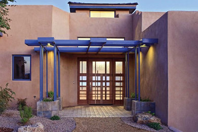 Trendy entryway photo in Albuquerque with a medium wood front door