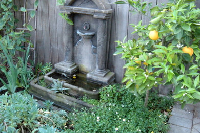 Design ideas for a mid-sized eclectic drought-tolerant and partial sun front yard brick garden path in Los Angeles.