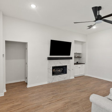 Minimalist Marble Fireplace & Media Center after remodel