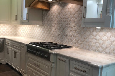 Kitchen - large traditional u-shaped kitchen idea in Dallas with beige backsplash, ceramic backsplash and an island