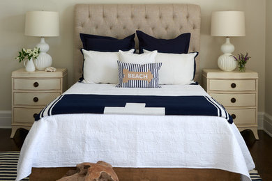 Beach style dark wood floor bedroom photo in New York with beige walls