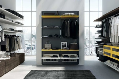 Mid-sized modern women's dressing room in Nice with open cabinets and yellow cabinets.