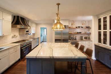 Inspiration for a large transitional medium tone wood floor and brown floor open concept kitchen remodel in New York with an undermount sink, shaker cabinets, gray cabinets, quartzite countertops, white backsplash, ceramic backsplash, black appliances, an island and multicolored countertops