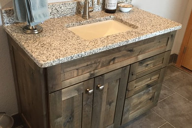 Example of a mid-sized mountain style 3/4 gray tile and subway tile porcelain tile and gray floor bathroom design in Other with shaker cabinets, distressed cabinets, a two-piece toilet, gray walls, an undermount sink and granite countertops