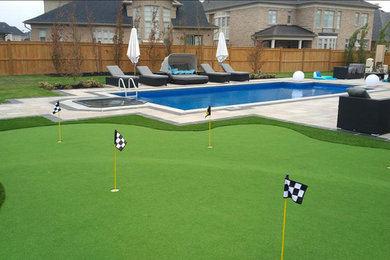 Design ideas for a large traditional backyard rectangular pool in Toronto with natural stone pavers.