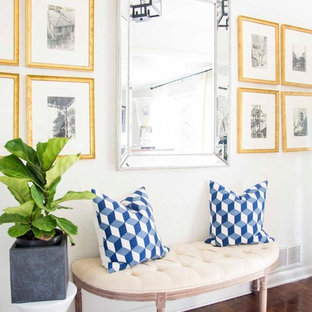 This is an example of a small eclectic foyer in Atlanta with white walls, medium hardwood flooring, a single front door, a white front door and brown floors.