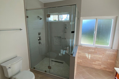 Alcove shower - large transitional master multicolored tile and porcelain tile porcelain tile, beige floor and double-sink alcove shower idea in Los Angeles with shaker cabinets, dark wood cabinets, a two-piece toilet, white walls, an undermount sink, quartz countertops, a hinged shower door, beige countertops and a freestanding vanity