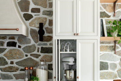 Example of a transitional kitchen design in Other with an island