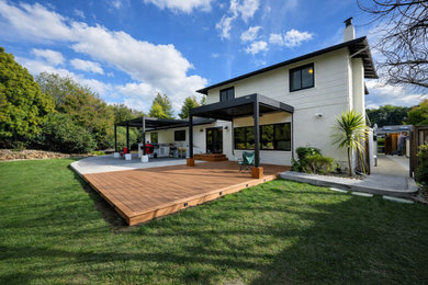 Example of a large minimalist backyard ground level deck design in San Francisco with a bbq area and a pergola