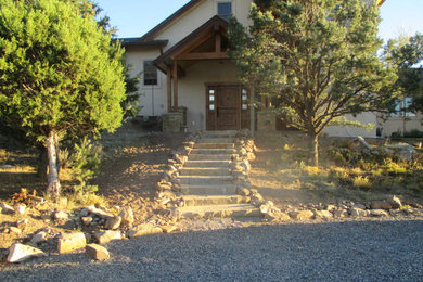 Rustic beige two-story stucco gable roof idea in Denver