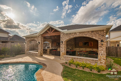 Inspiration for a large back patio in Houston with an outdoor kitchen and stamped concrete.
