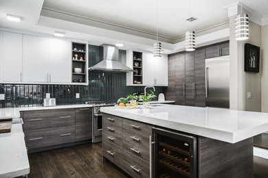 Example of a large minimalist u-shaped dark wood floor and brown floor eat-in kitchen design in New York with a farmhouse sink, flat-panel cabinets, brown cabinets, quartz countertops, green backsplash, glass tile backsplash, stainless steel appliances and an island