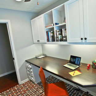 Small arts and crafts home office in Atlanta with brick floors and a built-in desk.