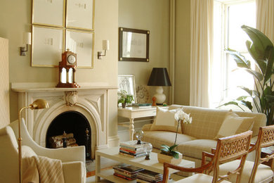 Inspiration for a timeless formal medium tone wood floor and beige floor living room remodel in Los Angeles with green walls and a standard fireplace