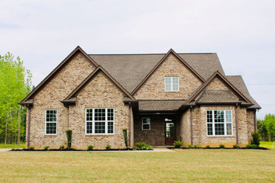 Mid-sized one-story brick house exterior idea in Other with a shingle roof