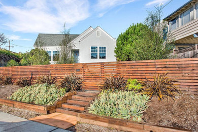 Photo of a mid-sized transitional full sun front yard retaining wall landscape in San Francisco.