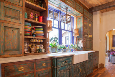 Mountain style galley eat-in kitchen photo in Dallas with a farmhouse sink, distressed cabinets, raised-panel cabinets and soapstone countertops