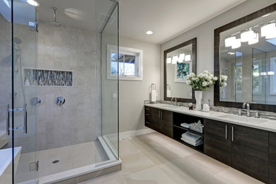 Inspiration for a mid-sized modern beige tile and ceramic tile ceramic tile, beige floor and double-sink bathroom remodel in Houston with flat-panel cabinets, dark wood cabinets, a one-piece toilet, beige walls, an undermount sink, quartz countertops, a hinged shower door, white countertops, a niche and a floating vanity